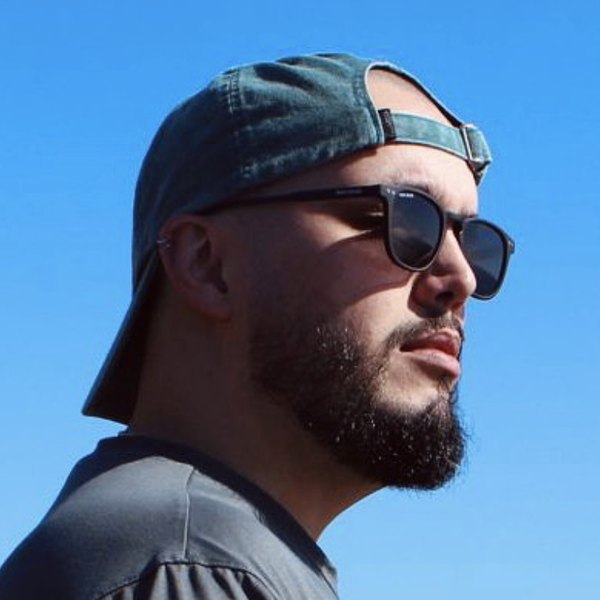 Marco Raizef, co-founder and CGO of Good Ground, wearing a cap and sunglasses under a blue Madeira sky