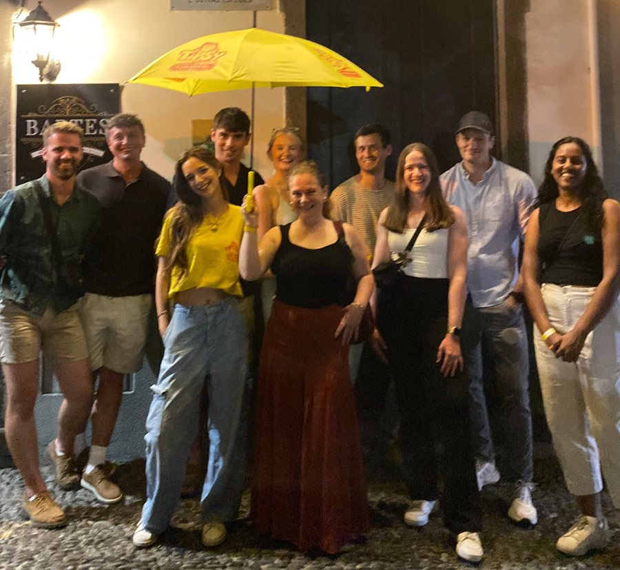 Guests posing with a yellow umbrella on a pub crawl night in Funchal