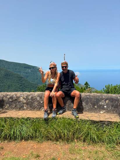 Two travelers at a coastal viewpoint over the Atlantic in Madeira