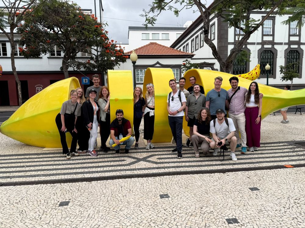 Group posing in front of a large yellow sculpture in central Funchal
