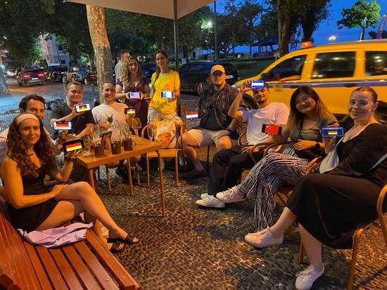 Guests sitting together on a bar terrace in Funchal at night