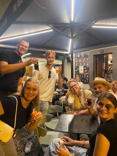 Guests sharing drinks at a bar during the Funchal pub crawl